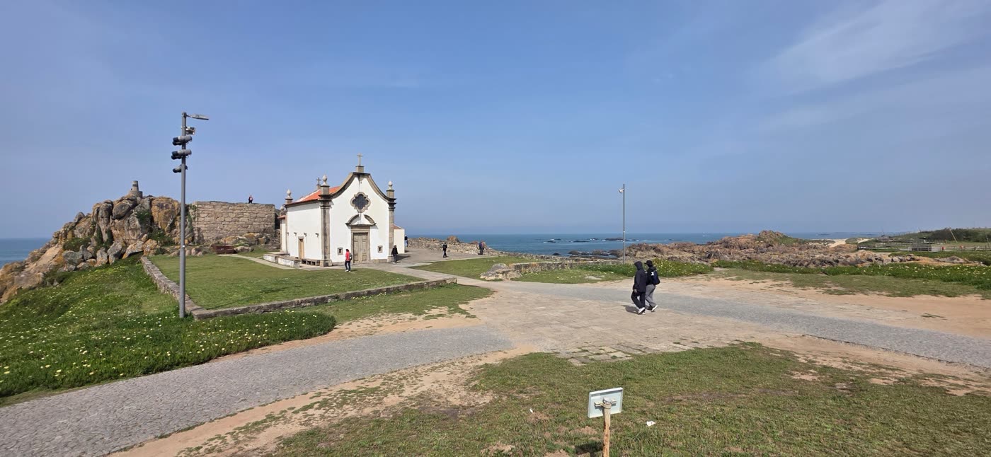 White chapel on a rocky point by the sea